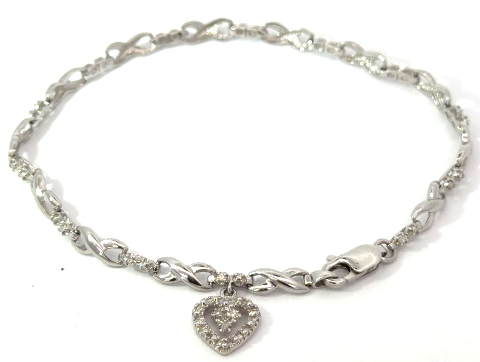 .jpg 10kt white gold diamond tennis bracelet with dangle heart tw 0.11cts SI3/I1 clarity, near colorless I/J color
