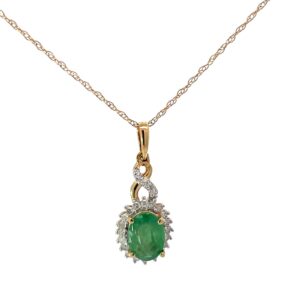 10kt yellow gold diamond and emerald oval halo pendant on machine made rope D tw 0.15cts I1,I