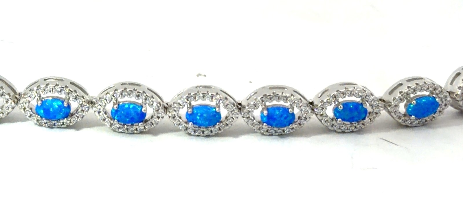 Sterling Silver rhodium plated created blue opal inlay halo marquis shape bracelet