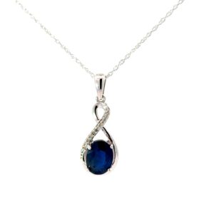 10kt white gold diamond and genuine oval sapphire pendant D tw 0.10cts SI2 clarity, near colorless J color on machine made rope 18"