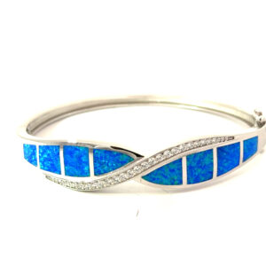Sterling Silver rhodium plated created blue opal inlay with cubic zirconia fashion X bangle with safety clasp