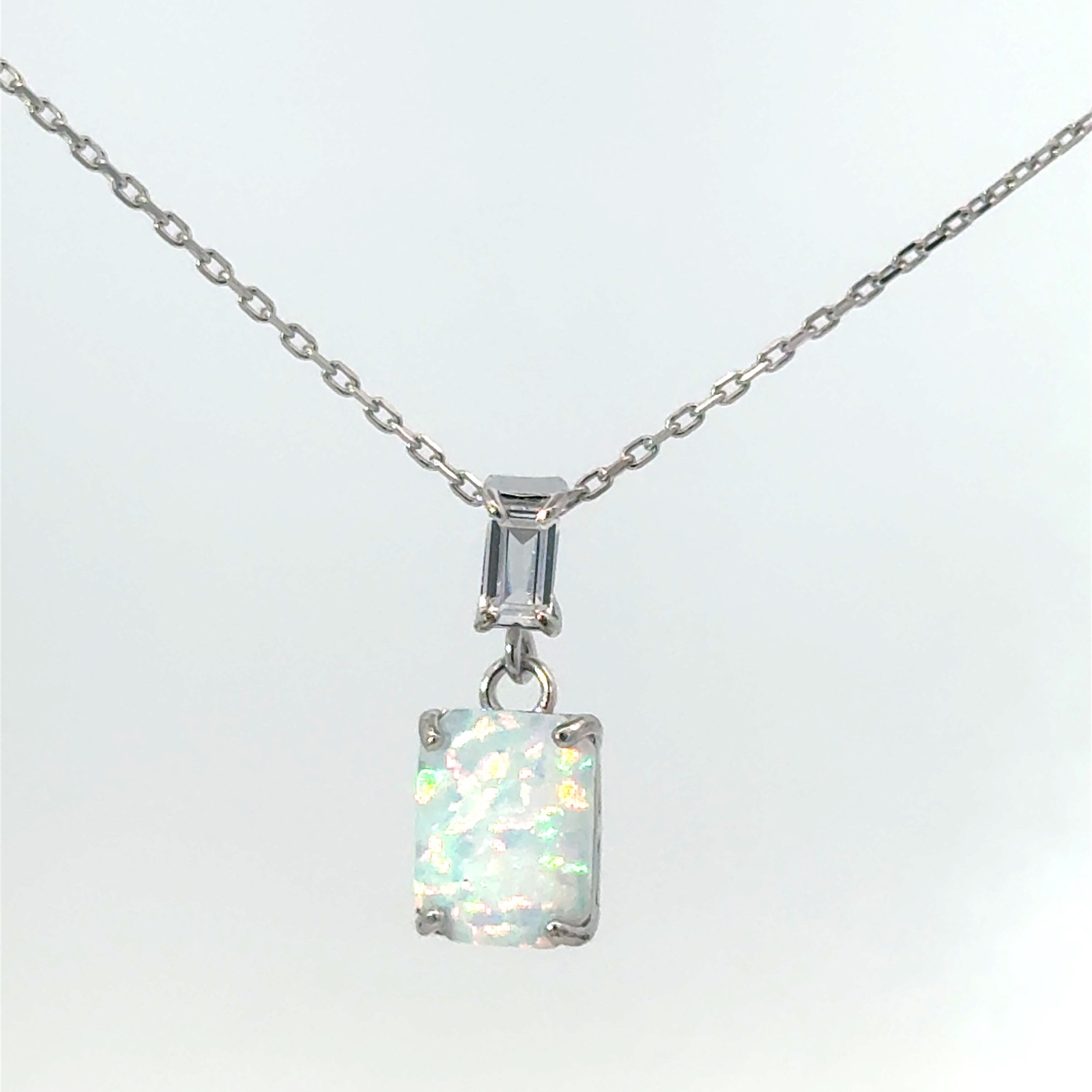 Sterling Silver Rhodium Plated Created White Opal Emerald Shape and CZ Baguette Pendant On 1.2Mm Diamond Cut Cable Chain 18"