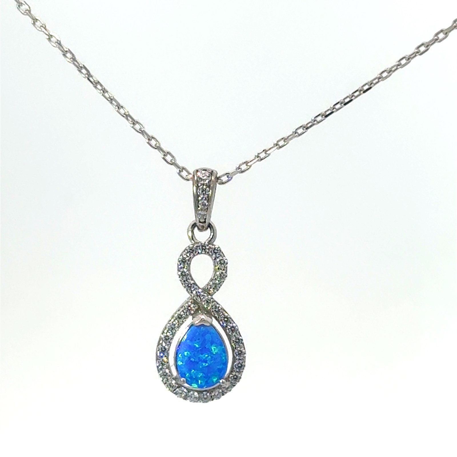 Sterling Silver Rhodium plated created blue opal and cubic zirconia halo pear shape pendant on 1.2mm diamond cut cable