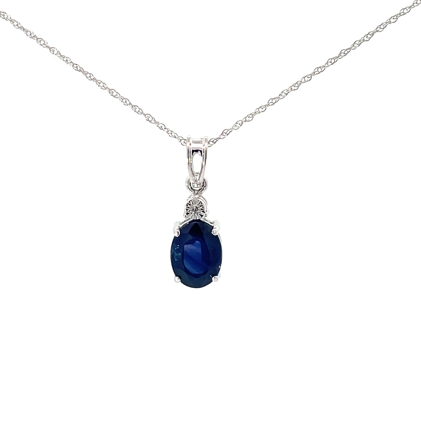 .jpeg 10kt white gold illusion set diamond and genuine sapphire pendant on an 18" machine made rope