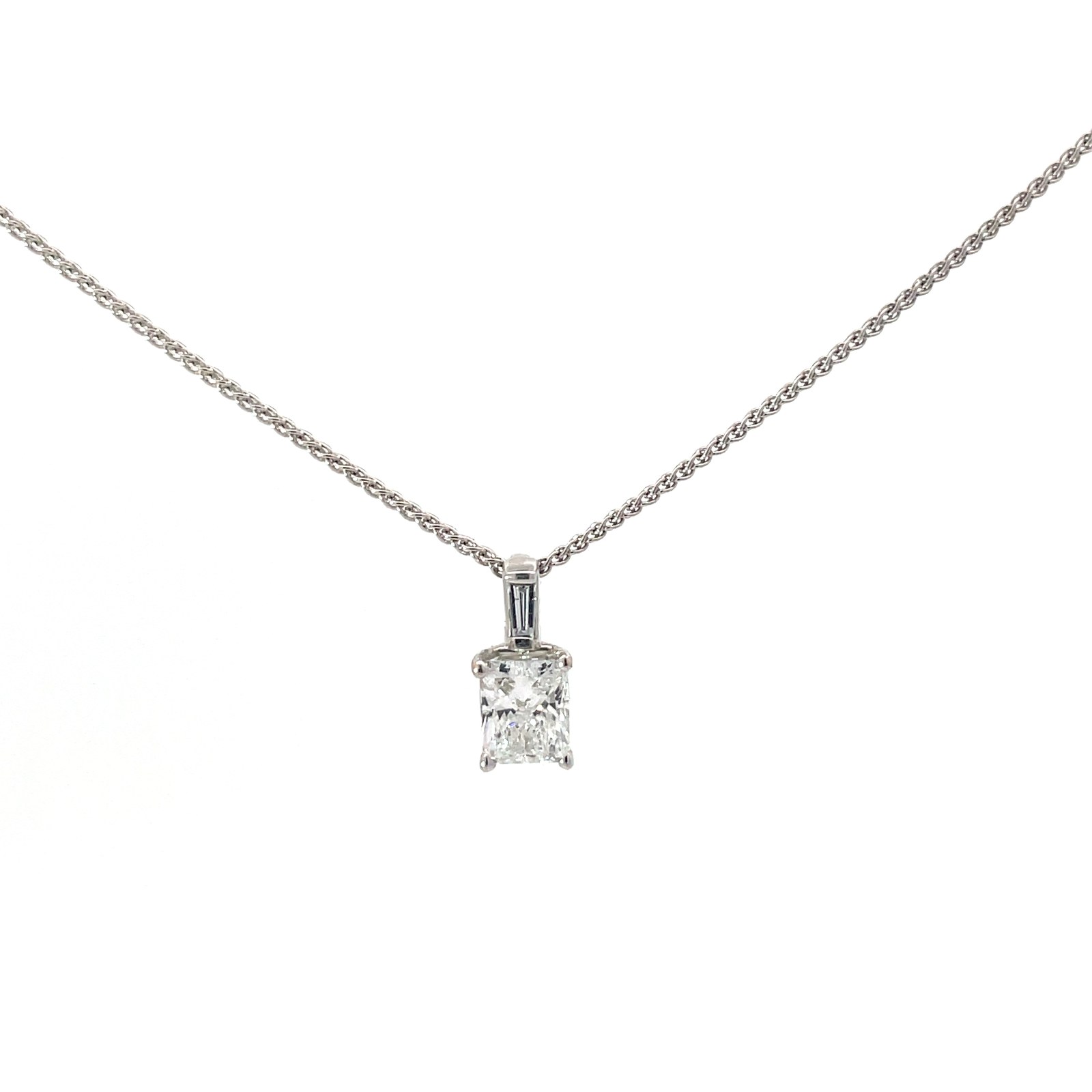 .ctdia 14kt wg diam pend center radiant tw 0.82 cts, 1 baguette tw 0.05pt TDW 0.87 cts SI1, F/G on 18" wheat