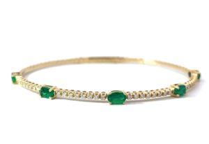 14kt yellow gold diamond and genuine emerald flex bangle bracelet D tw0.29cts E tw 1.28cts SI clarity, near colorless I color