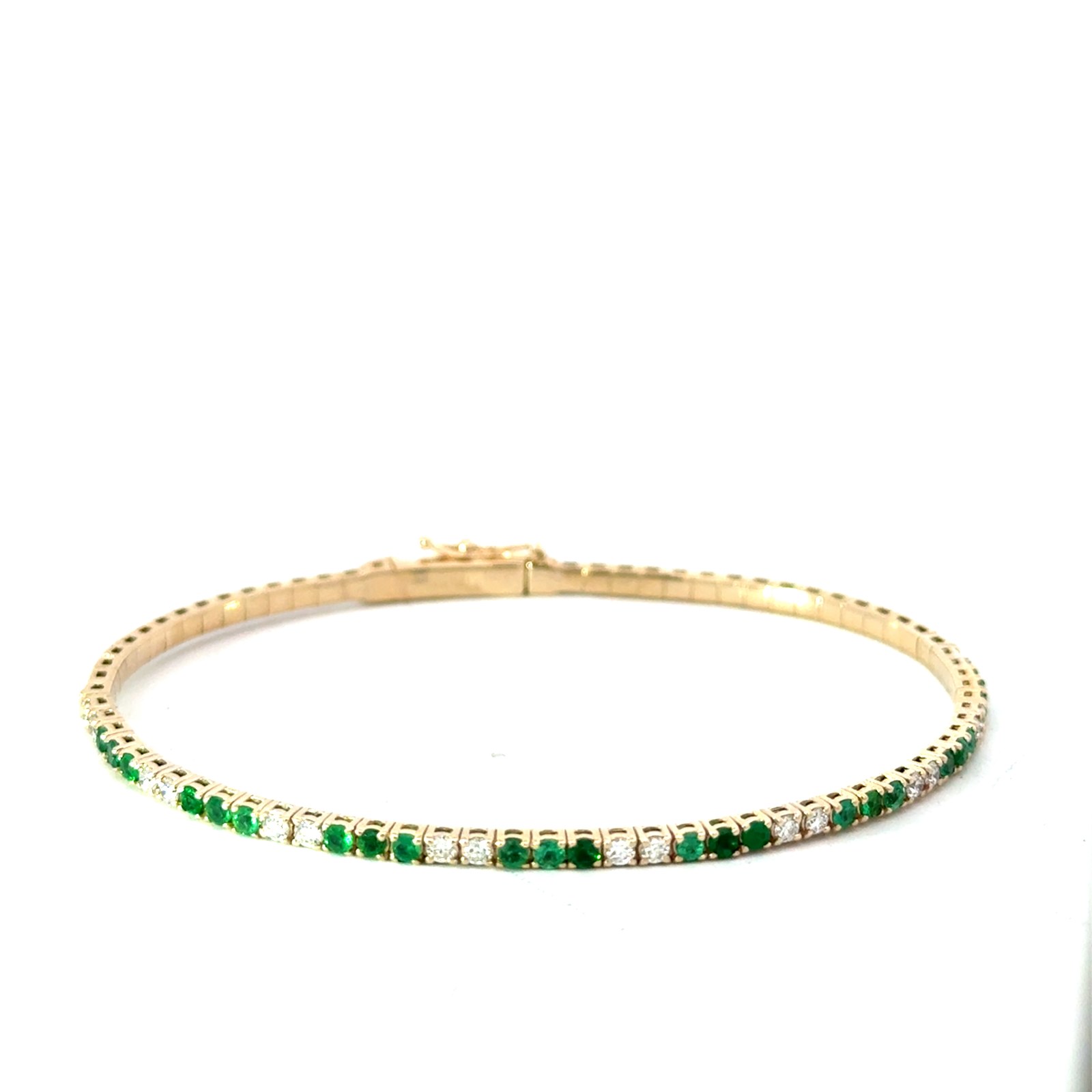 14kt y/g genuine emerald and diamond flex bangle bracelet D tw 0.43cts SI clarity, near colorless H E tw 0.67cts with foldover safety