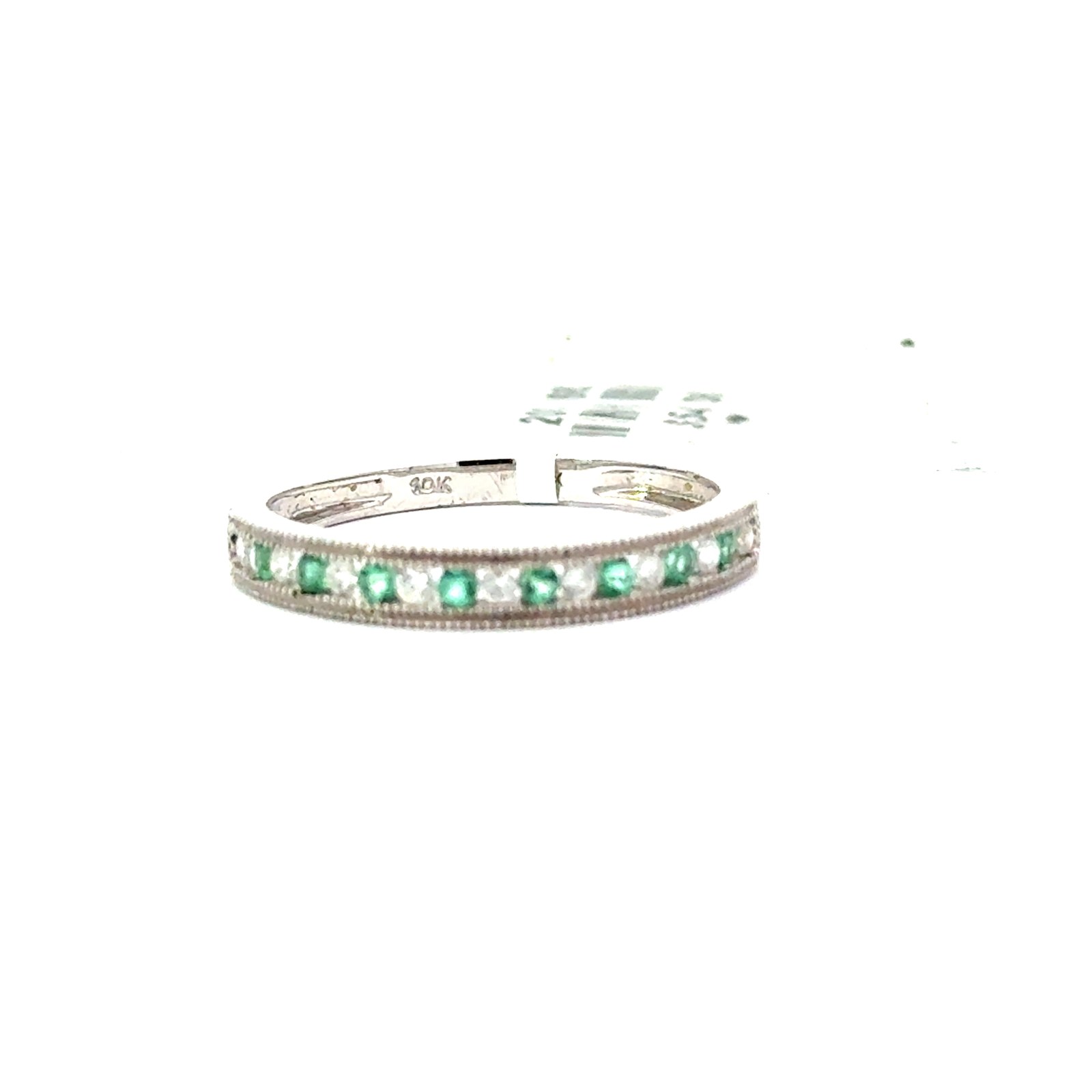 MRV .jpg 10kt white gold diamond and genuine emerald band channel set with a milgrain edge tw 0.13 cts E tw0.10