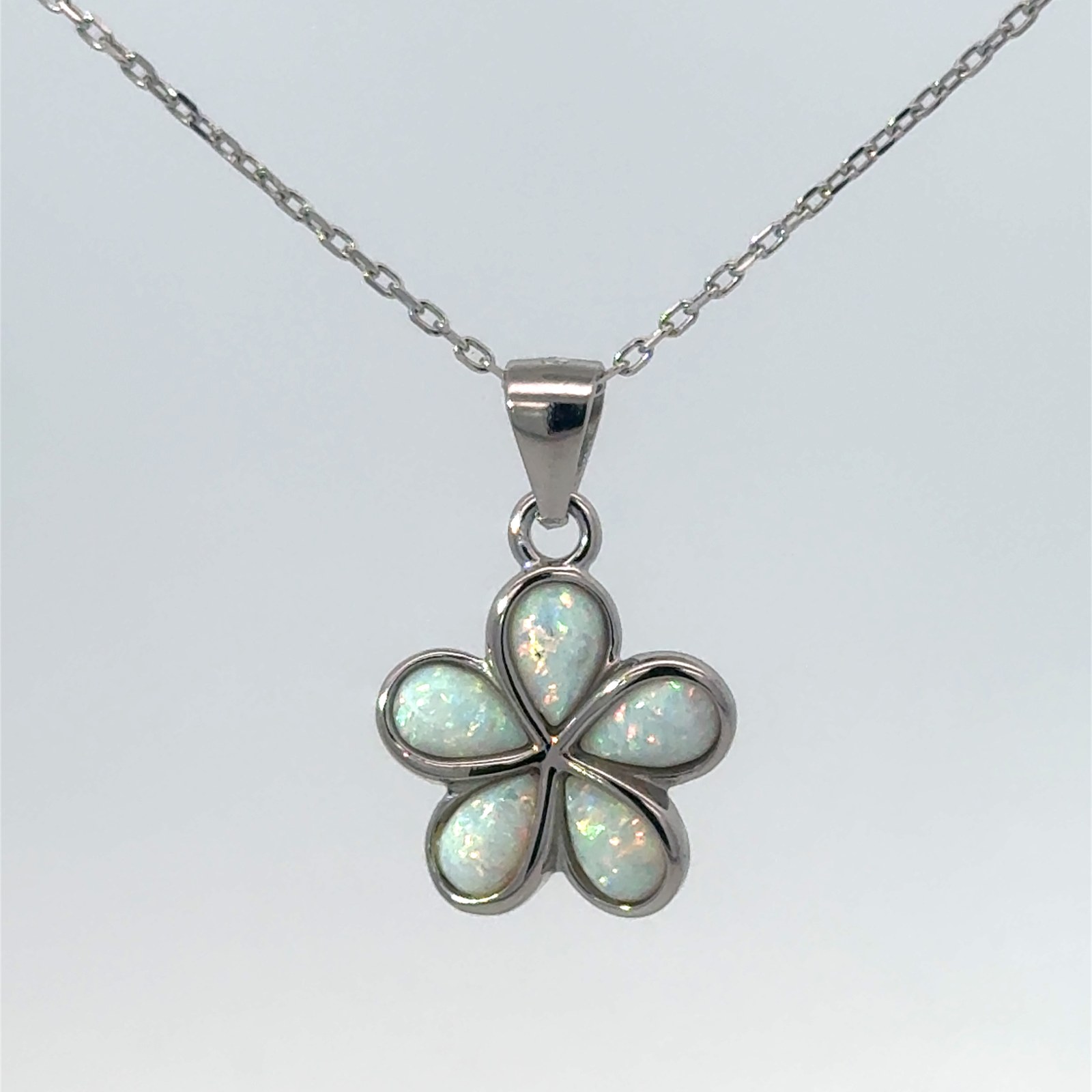 Sterling Silver rhodium plated created white opal plumeria flower pendant on 1.2mm diamond cut cable chain 18"