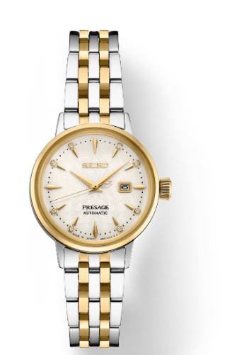 SUR .jpg Ladies Seiko ivory dial with a subtle center radial pattern, gold hands, and gold-tone Arabic numerals for, including a classic cabochon crown bracelet style WR 50M